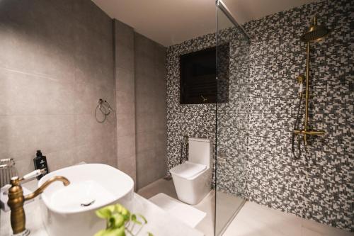 a bathroom with a toilet and a sink and a shower at Hiriketiya Beach Resort in Hiriketiya