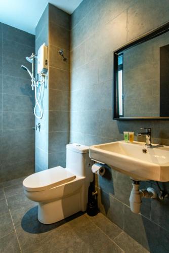 a bathroom with a toilet and a sink at Neu Suites KL with Daily Breakfast Included in Kuala Lumpur