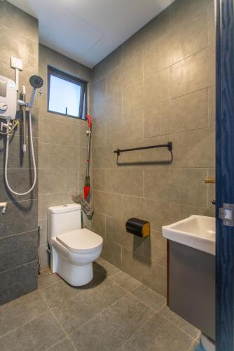 a bathroom with a toilet and a sink at Neu Suites KL with Daily Breakfast Included in Kuala Lumpur