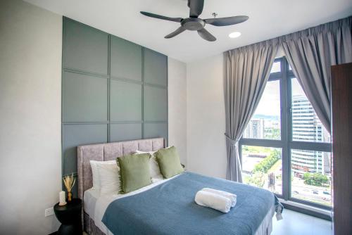 a bedroom with a bed with a ceiling fan at Neu Suites KL with Daily Breakfast Included in Kuala Lumpur