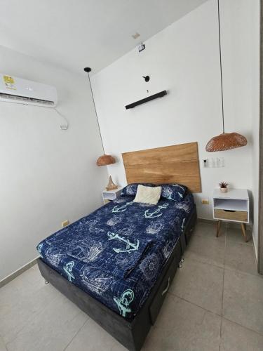 a bedroom with a bed and two pendant lights at Paraiso Coveñas, Unidad con la mejor piscina in Coveñas