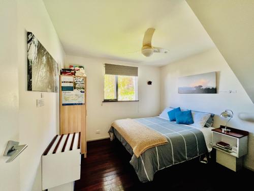 a bedroom with a bed and a window at Sunrise on Falie Seaview Eco Accommodation in American River