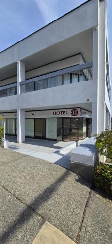 a large building with a hotel sign in front of it at New Royal Inn in New Westminster