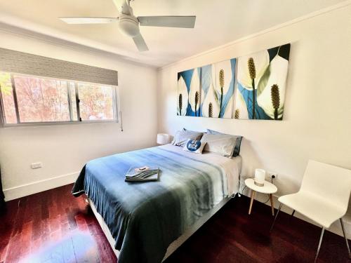 a bedroom with a bed and a ceiling fan at Sunrise on Falie Seaview Eco Accommodation in American River