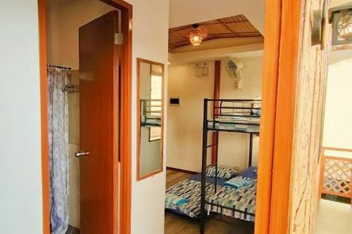 a hallway with a room with bunk beds and a door at Intoy's Place Panglao near Beach in Panglao