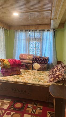 a large bed with pillows on it in a room at The Good Time homestay in Jālāpahār