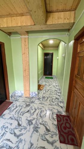 an empty room with a large marble floor at The Good Time homestay in Jālāpahār