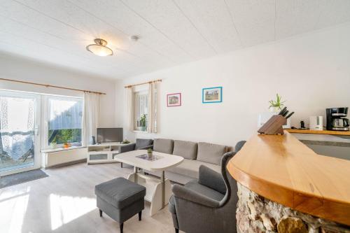 a living room with a couch and a table at Ferienwohnungen Behling am Schufutsberg in Liepe
