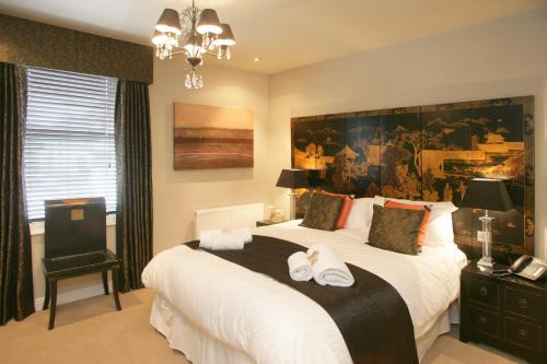
a bedroom with a large bed and a large window at Urban Beach Hotel in Bournemouth
