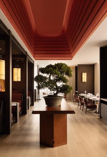 a bonsai tree sitting on a table in a room at Capella Taipei in Taipei