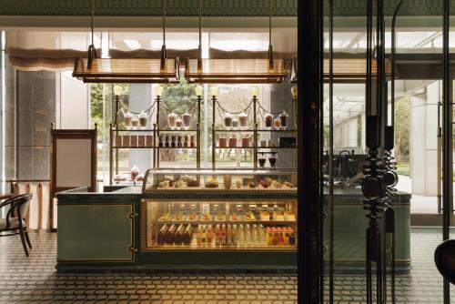 a display case in a restaurant with bottles of alcohol at Capella Taipei in Taipei