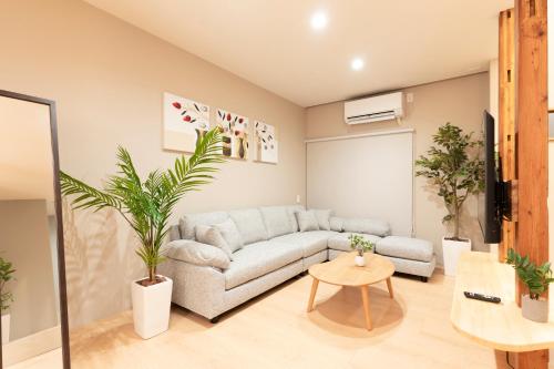 a living room with a couch and a table at 凪ノ家曳舟 Naginoya Hikihune in Tokyo