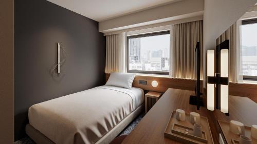 Ένα ή περισσότερα κρεβάτια σε δωμάτιο στο Quintessa Hotel Hiroshima Kanayamacho