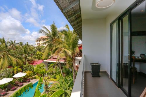 a view from the balcony of a resort with palm trees at Angkor Home 27 in Phumĭ Réach Born
