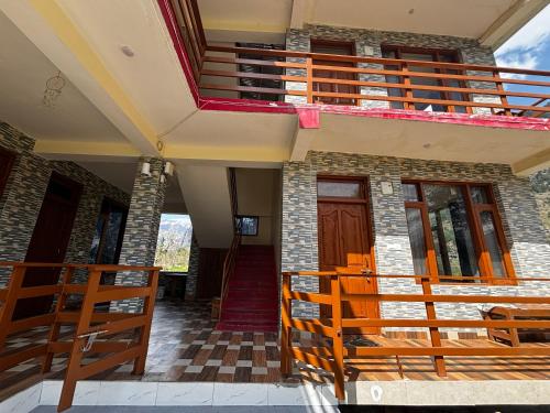 a house with a staircase and a balcony at By The Way in Manāli