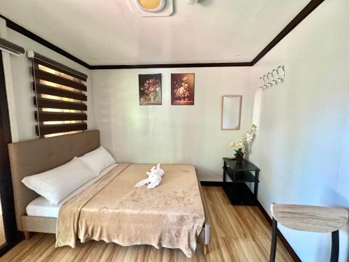 a small bedroom with a bed with a stuffed animal on it at Nazarene Apartelle -R3 in Mambago-B