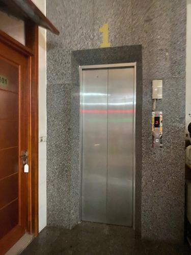 a metal elevator in a building with a rainbow on it at Tấn Đạt Hotel Quy Nhơn in Quy Nhon