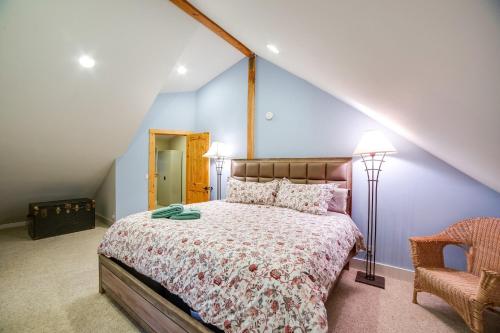 a bedroom with a large bed and a chair at Glacier Springs Cabin 12 - Pet Friendly, WIFI, AC, Sleeps 4 in Deming