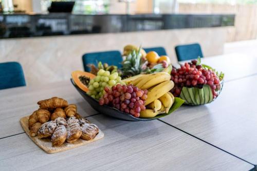 two bowls of fruit and vegetables on a table at Rydges Esplanade Resort Cairns in Cairns