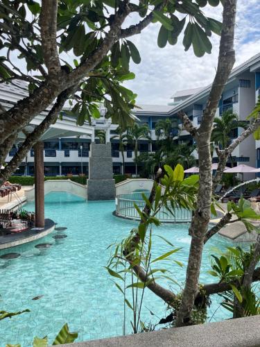 a swimming pool in the middle of a resort at Phuket Island View Resort - SHA Extra Plus in Karon Beach
