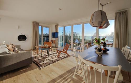 a living room with a table and chairs and a couch at Penthouse Deluxe in Lembruch