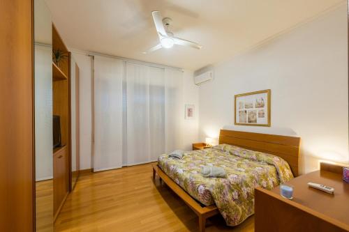 a bedroom with a bed and a desk and a television at Alice's Apartment in Civitavecchia