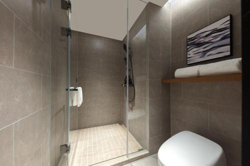 a bathroom with a shower with a toilet in it at Atour Hotel Chengyang Road Xiangcheng District Suzhou in Suzhou
