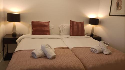 two beds in a bedroom with towels on them at Cohost Partners 3 Bed Apartment in Warrington in Warrington