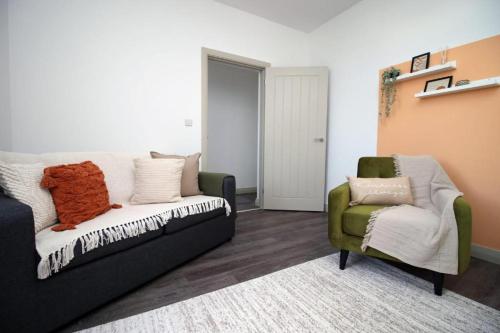 a living room with a couch and a chair at Cohost Partners Charming 3BR Near City Centre Parking in Newport