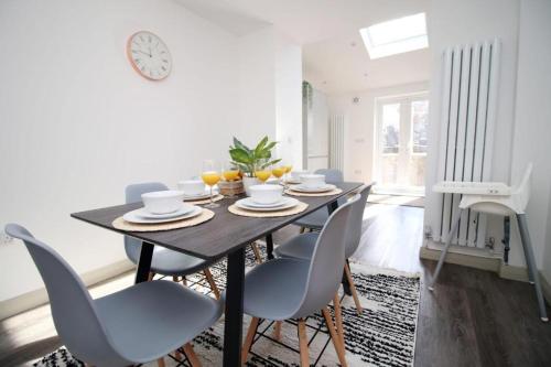 a dining room with a table and chairs at Cohost Partners Charming 3BR Near City Centre Parking in Newport
