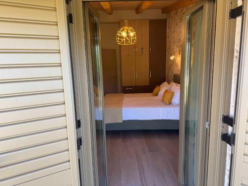 a door leading to a bedroom with a bed at Skandalis Apartments with pool in Chorafakia