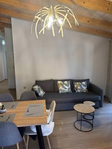 a living room with a couch and a table at Skandalis Apartments with pool in Chorafakia