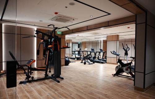 a gym with several treadmills and exercise bikes at Elite Haven in Al Madinah