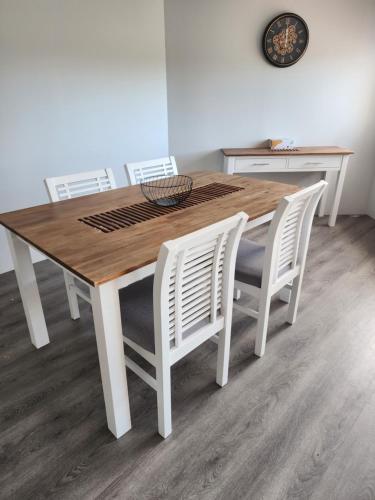 a dining room table with white chairs around it at Bayview Anchorage in Gold Coast