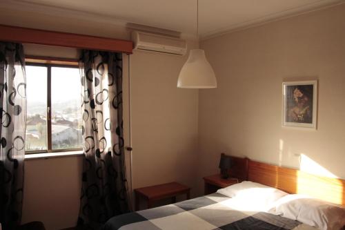 Postel nebo postele na pokoji v ubytování Residencial Dom Manuel