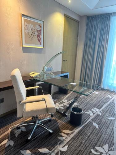 an office with a glass desk and a chair at The Jade Boutique Hotel in Wuhan