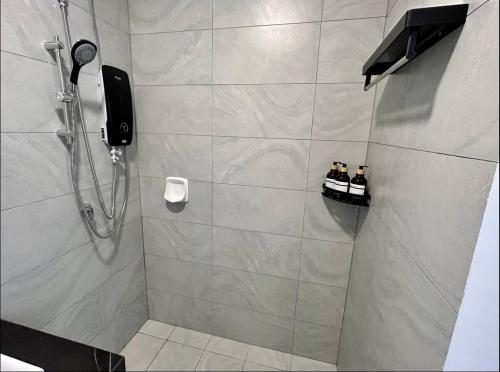 a bathroom with a shower with two pairs of shoes at 1810 SkyTree bukitindah Aeon Legoland 2-3pax in Johor Bahru