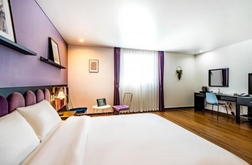 a hotel room with a bed and a desk at Hotel Hyggelig in Busan