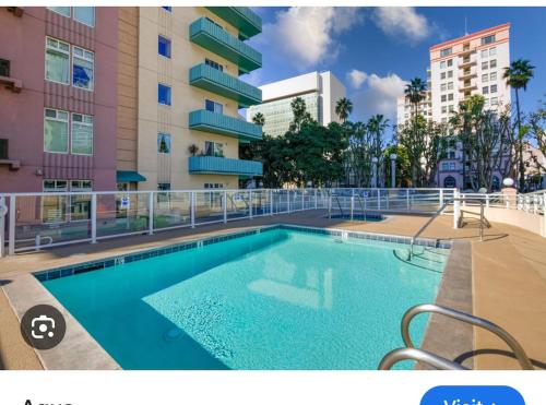 a swimming pool in front of a building at Ocean View Suite by Convention Center & Beach in Long Beach
