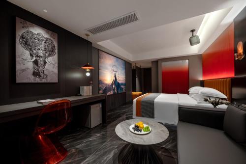 a hotel room with a bed and a table with a plate of food at 西双版纳景洪恩季国际酒店 in Jinghong