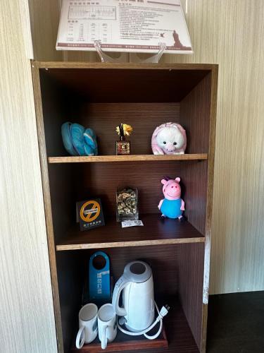 a wooden cupboard with various items in it at 卡蹓英雄館 in Ma-tsu