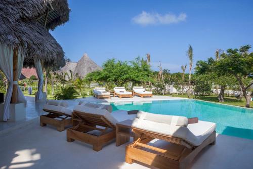 a pool with chaise lounge chairs and a resort at The Kasa Malindi in Malindi