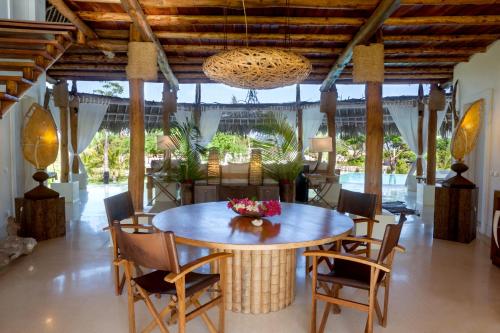 a dining room with a table and chairs at The Kasa Malindi in Malindi