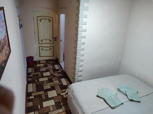 a room with a bed with two towels on it at Family Guest house - Friends-J in Nukus