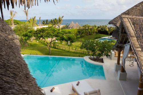 an infinity pool at the resort with the ocean in the background at The Kasa Malindi in Malindi