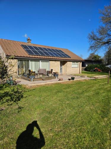 a shadow of a person with solar panels on a house at Greenways at Coed Cae Farm in Pontnewydd
