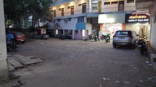 a parking lot with a car parked in front of a building at Hotel Sangam sagar in Sāgar