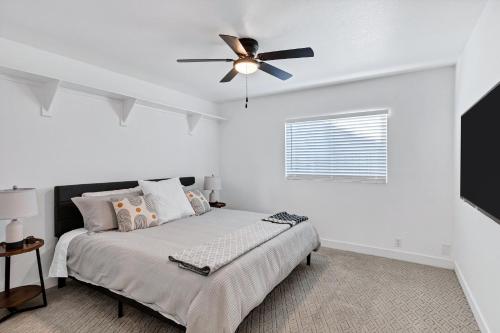 a bedroom with a bed with a ceiling fan at NEW! Luxe Vacation Retreat - heated pool, putting green in Peoria