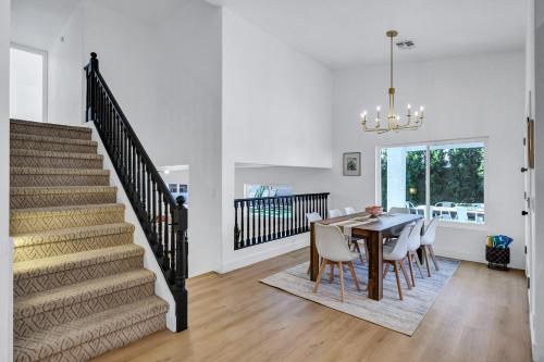 a dining room and kitchen with a table and chairs at NEW! Luxe Vacation Retreat - heated pool, putting green in Peoria