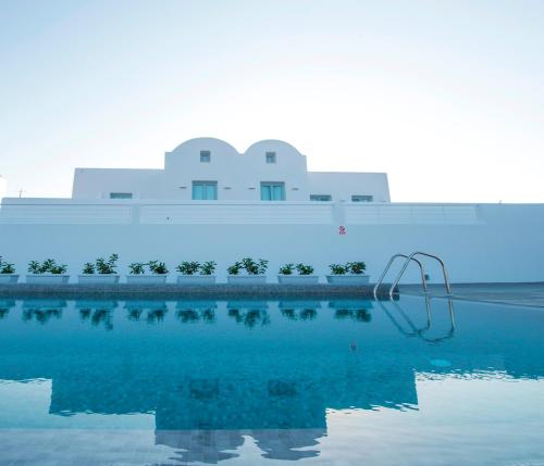 a large building with a reflection in the water at SEA villa in Monolithos